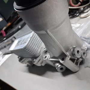 The product is a 2011 to 2016 aluminum oil filter housing complete with seals and switch filter gaskets. It is designed for easy installation and made with rubber gasket material. This oil filter housing is a crucial component for maintaining the engine of a vehicle, providing a secure seal to prevent leaks and ensure optimal filtration. The included gaskets and seals ensure a complete and proper fit, making it a reliable choice for automotive maintenance and repai