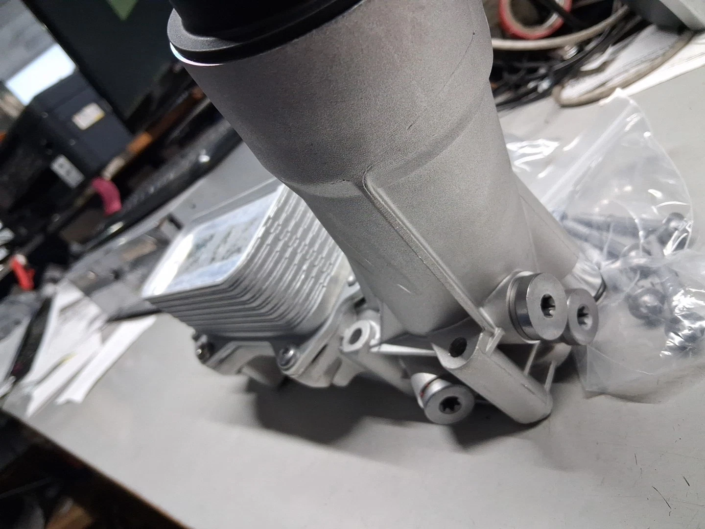 The product is a 2011 to 2016 aluminum oil filter housing complete with seals and switch filter gaskets. It is designed for easy installation and made with rubber gasket material. This oil filter housing is a crucial component for maintaining the engine of a vehicle, providing a secure seal to prevent leaks and ensure optimal filtration. The included gaskets and seals ensure a complete and proper fit, making it a reliable choice for automotive maintenance and repai